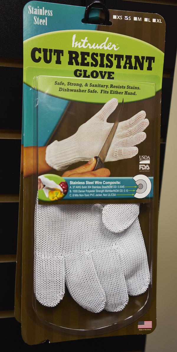 Package of cut-resistant gloves hanging on display rack